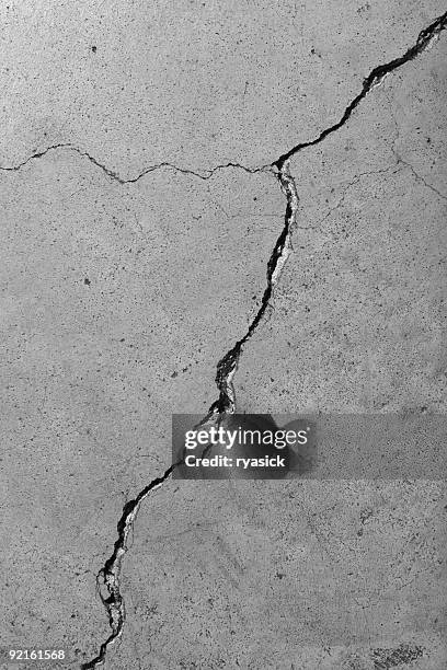 closeup detail of diagonal cracks in cement floor - cement stock pictures, royalty-free photos & images