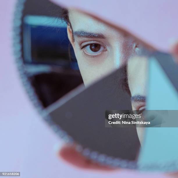 reflection of brown female eye in broken mirror - broken mirror stock pictures, royalty-free photos & images
