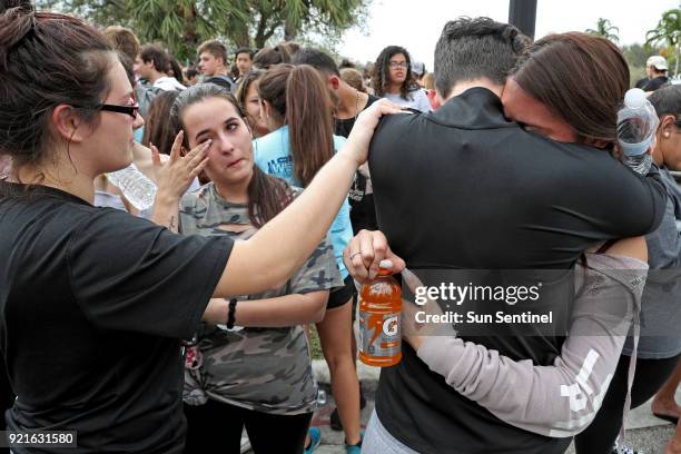 West Boca Raton Community High School sophomore Leona Zaborsky right, and senior Julia Wheeler hug after reaching Marjory Stoneman Douglas High...