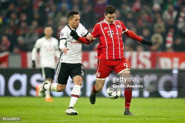 Adriano Correia of Besiktas and Robert Lewandowski of Bayern Munich vie for the ball during the UEFA Champions League Round of 16 soccer match...