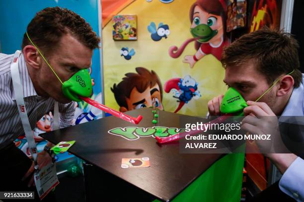 Exhibitors play "Tic Tac Tongue" from Yulu Toys during the annual New York Toy Fair, at the Jacob K. Javits Convention Center on February 20 in New...
