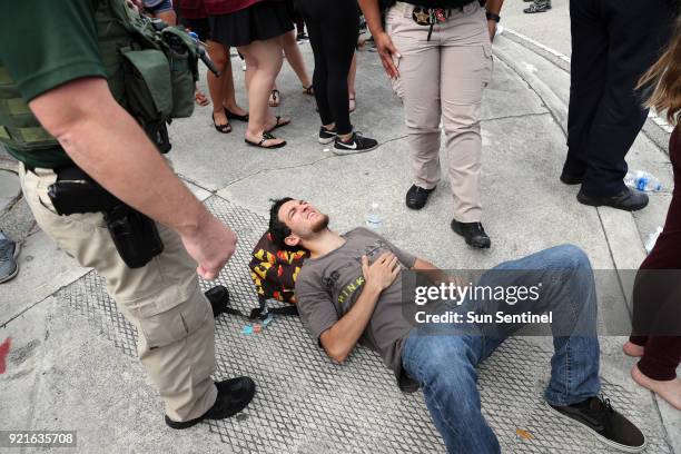 West Boca Raton Community High School student waits for medical attention after walking to Marjory Stoneman Douglas High School in Parkland, Fla. On...