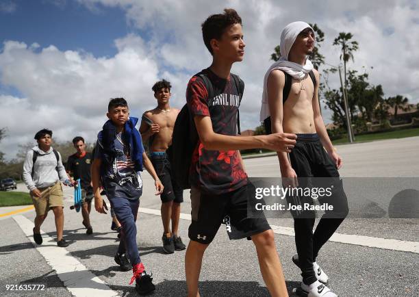 Some of the hundreds of West Boca High School students arrive at Marjory Stoneman Douglas High School after they walked there in honor of the 17...