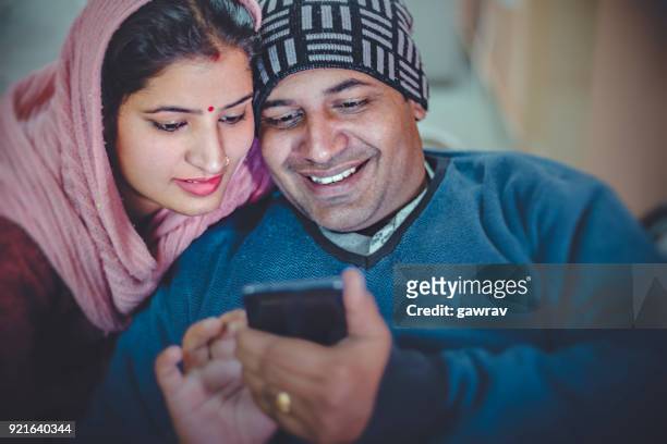 Couple sharing smart phone together.