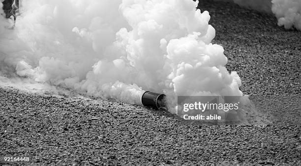 tear gas in motion in black and white  - military parade stock pictures, royalty-free photos & images