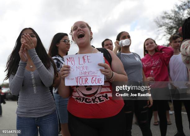 Tiffany Bogert cheers on some of the hundreds of her classmates from West Boca High School as they arrive at Marjory Stoneman Douglas High School...
