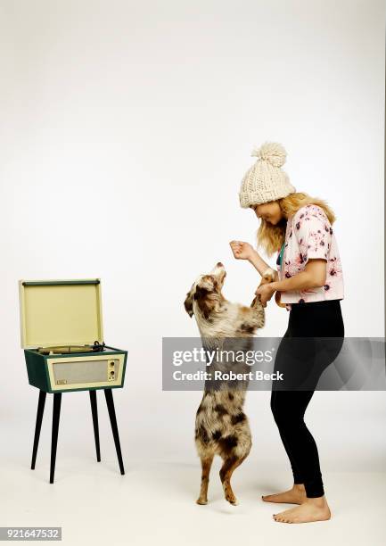 Portrait of USA Chloe Kim posing with her Australian shepherd dog Reese and gold medal during photo shoot at Los Coyotes Country Club. Kim won gold...