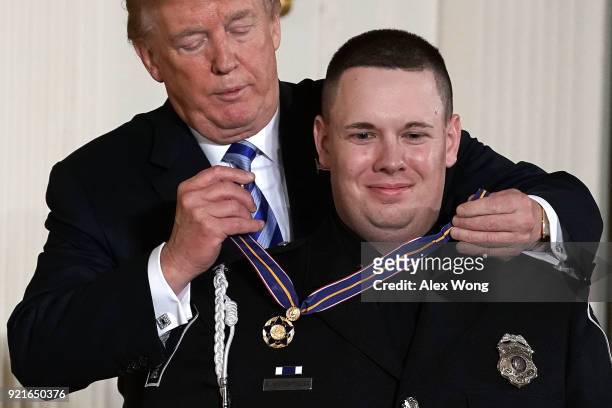 President Donald Trump presents the Public Safety Medal of Valor to Officer Andrew Hopfensperger of Antigo Police Department in Wisconsin during an...
