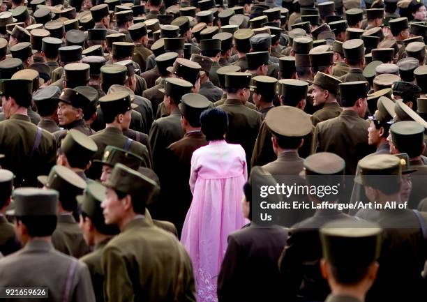 North Korean woman in pink choson-ot in the middle of soldiers, Pyongan Province, Pyongyang, North Korea on April 13, 2008 in Pyongyang, North Korea.