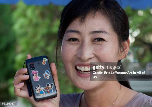 North Korean woman with disney characters stickers on her mobile phone, North Hwanghae Province, Pyongyang, North Korea on September 10, 2011 in...