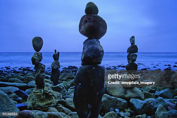 beach stones balanced - ebb tide stock pictures, royalty-free photos & images