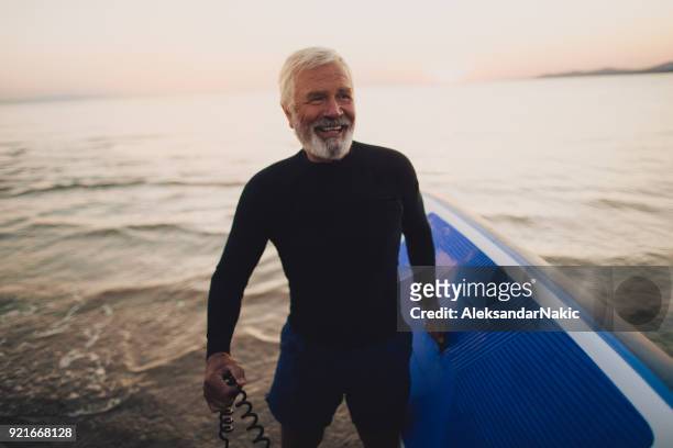 senior surfer - fitness cool attitude stock pictures, royalty-free photos & images