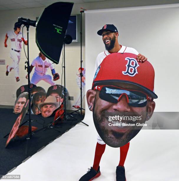 Boston Red Sox pitcher David Price has a laugh while holding an oversized cutout of his face as players posed for promotional photos during spring...