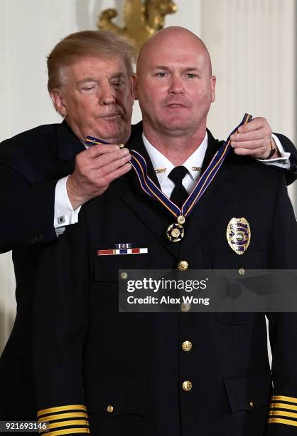 President Donald Trump presents the Public Safety Medal of Valor to Chief Douglas Schroeder of Hesston Police Department in Kansas during an award...