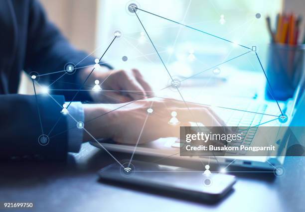 businessman hand working on laptop computer on wooden desk as concept and technology social media network diagram - financial planning abstract stock pictures, royalty-free photos & images