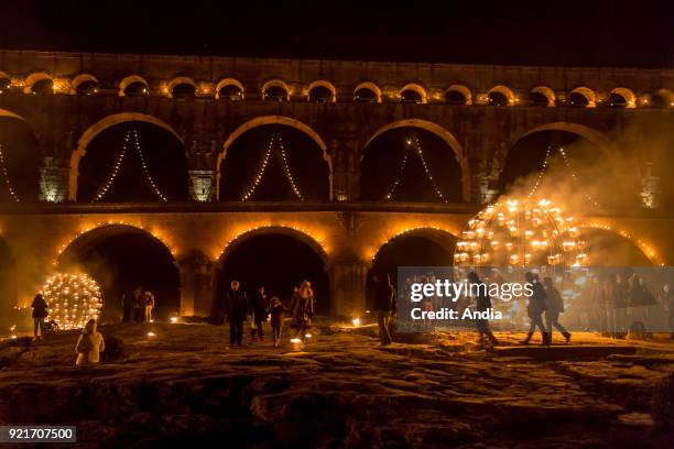 The 'Pont du Gard' bridge, ancient Roman aqueduct that crosses the Gardon River, lit up at night on the occasion of the show entitled 'Nuit des...