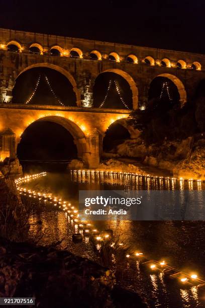 The 'Pont du Gard' bridge, ancient Roman aqueduct that crosses the Gardon River, lit up at night on the occasion of the show entitled 'Nuit des...