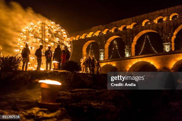 The 'Pont du Gard' bridge, ancient Roman aqueduct that crosses the Gardon River, lit up at night on the occasion of the show entitled 'Nuit des...
