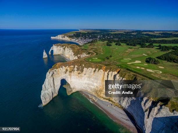 Etretat : cliffs along the Norman coast 'Cote d'Albatre'. The golf course on top of the cliff, the arches 'Manneporte' and 'Porte d'Aval', L'Aiguille...