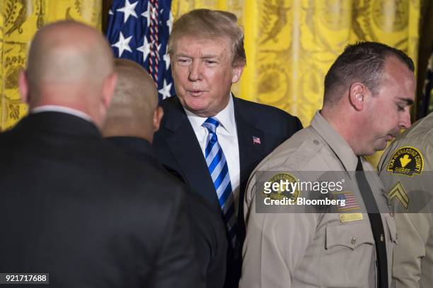 President Donald Trump shakes hands with San Bernardino County law enforcement officials during a Public Safety Medal of Valor awards ceremony in the...