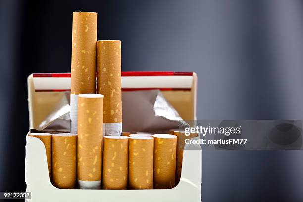 an up close view of a package of several cigarettes  - cigarette pack stock pictures, royalty-free photos & images