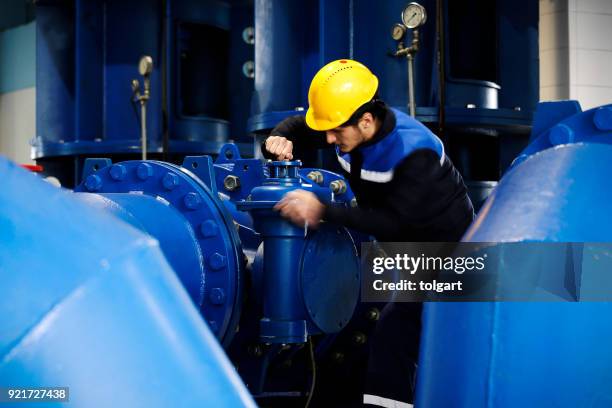 worker checking the oil pipeline equipment - oil pipeline stock pictures, royalty-free photos & images