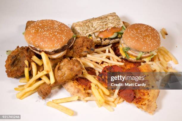 In this photo illustration, fast food from a branch of McDonald's, Burger King, KFC, Subway and Domino's pizza is pictured on February 20, 2018 in...