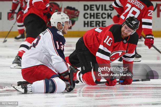 Jimmy Hayes of the New Jersey Devils and Cam Atkinson of the Columbus Blue Jackets chat during warm-ups prior to the game at Prudential Center on...