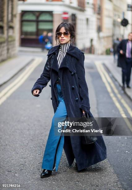 Camila Cabello wearing striped shirt Eloshi, blue pants Eloshi, boots Guiseppe Zanotti, sunglasses Tods, earrings Monse, navy coat Nina Ricci, bag...