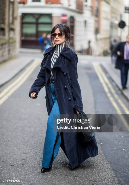 Camila Cabello wearing striped shirt Eloshi, blue pants Eloshi, boots Guiseppe Zanotti, sunglasses Tods, earrings Monse, navy coat Nina Ricci, bag...