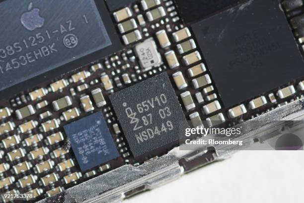 Semiconductors NV controller chip, center, of an Apple Inc. IPhone 6 smartphone in seen in an arranged photograph in Bangkok, Thailand, on Saturday,...