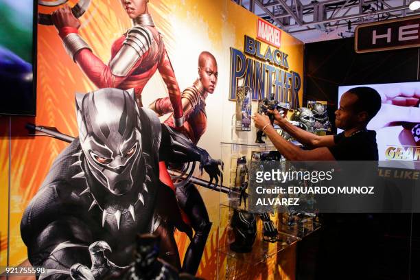 An exhibitor organizes "Black Panther" items at the Hasbro showroom during the annual New York Toy Fair, on February 20 in New York. Panther claws,...