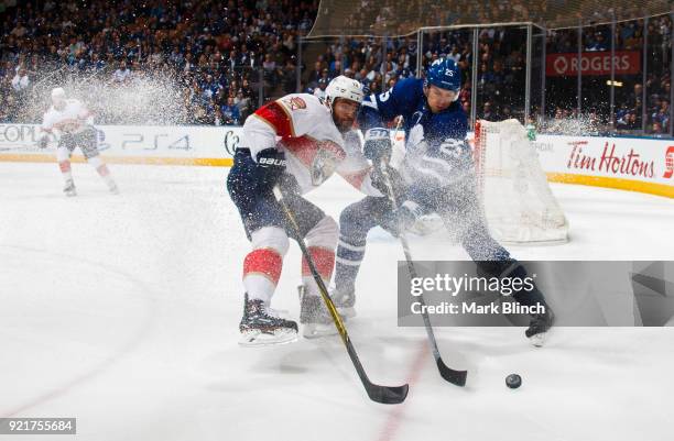 James van Riemsdyk of the Toronto Maple Leafs and Ian McCoshen of the Florida Panthers battle for the puck during the first period at the Air Canada...