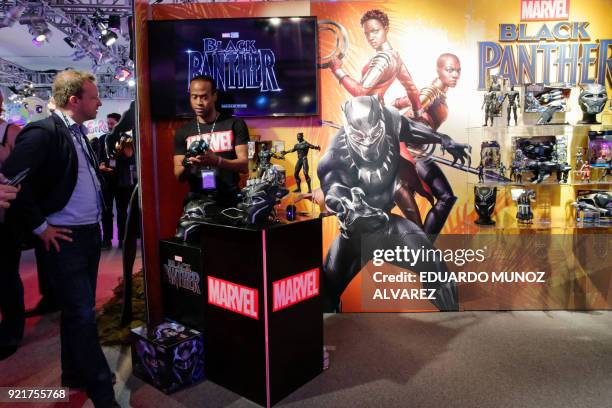 An exhibitor shows "Black Panther" items to attendees at the Hasbro showroom during the annual New York Toy Fair, on February 20 in New York. Panther...