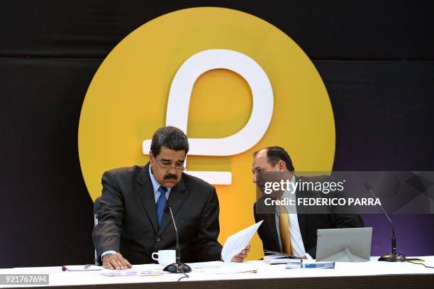 Venezuela's President Nicolas Maduro speaks with Venezuela's Minister of Science, Technology and University Education Hugbel Roa during a press...