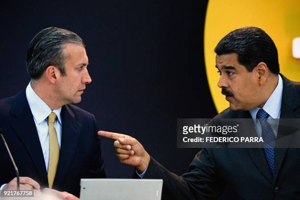 Venezuela's President Nicolas Maduro speaks with Vice-President Tarek El Aissami during a press conference to launch to the market a new oil-backed...