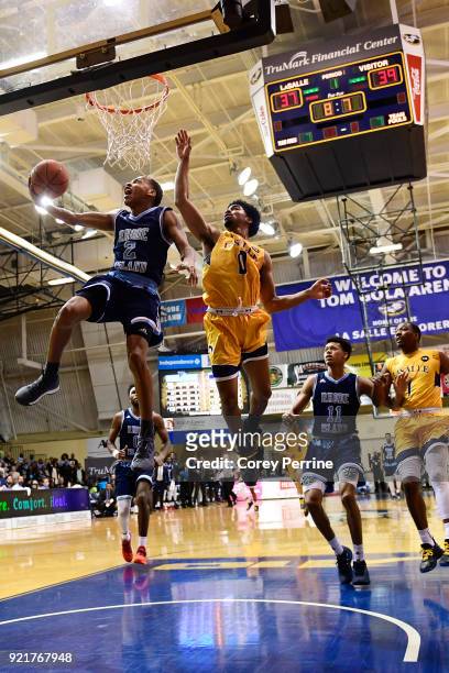 Fatts Russell of the Rhode Island Rams drives to the basket against Pookie Powell of the La Salle Explorers during the first half at Tom Gola Arena...