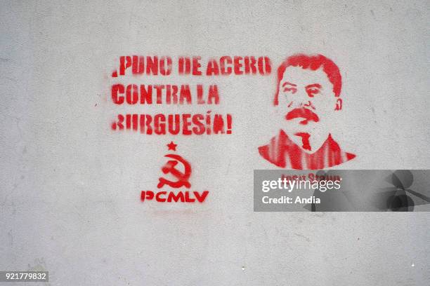 Venezuela, Santiago de Leon de Caracas: mural painting in the city depicting Stalin with the slogan 'Puno de acero contra la burguesia', a steel fist...