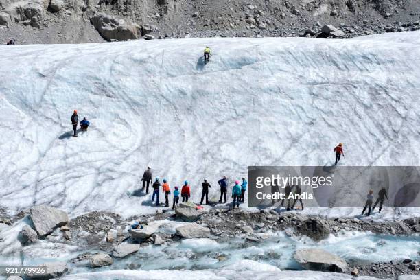 Chamonix-Mont-Blanc . Amateur mountaineers on the valley glacier 'Mer de Glace'.
