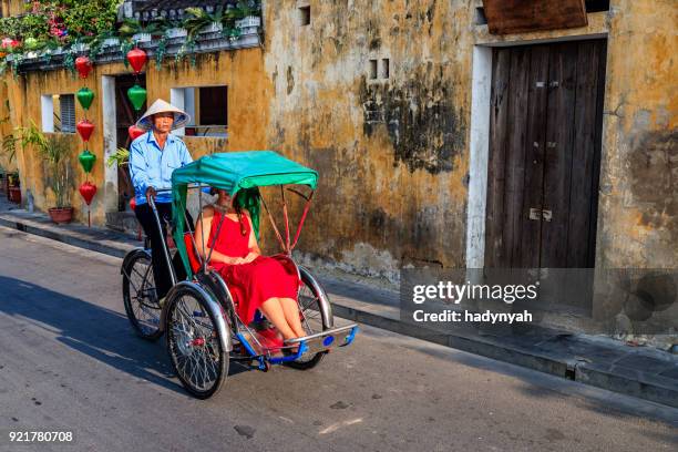 vietnamese cycle rickshaw in old town in hoi an city, vietnam - brouette stock pictures, royalty-free photos & images