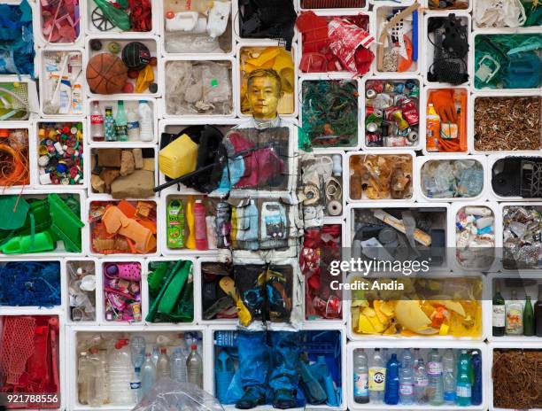 Camouflage artist Liu Bolin at the Surfrider Foundation in Biarritz, blended into a background of rubbish collected on the Basque Coast with the aim...