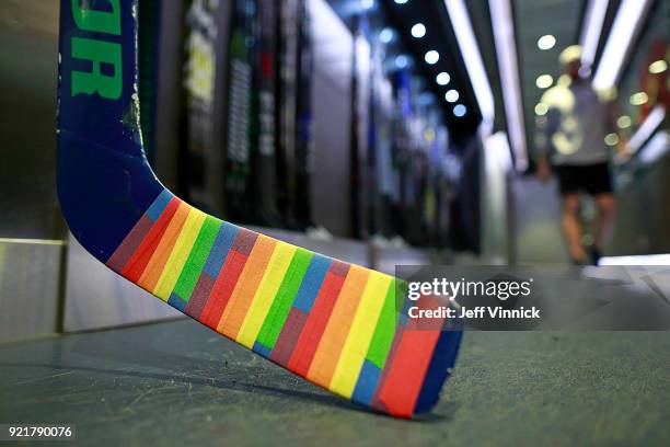 The goal stick of Anders Nilsson of the Vancouver Canucks is covered in Pride tape as it sits in the Canucks dressing room before their NHL game...