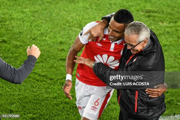 Colombia's Independiente Santa Fe defender William Tesillo celebrates with his coach, Uruguayan Gregorio Perez after scoring a goal against Chile's...