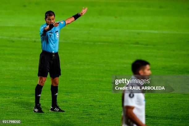 Peruvian referee Victor Carrillo gives instructions during a 2018 Copa Libertadores football match between Colombia's Independiente Santa Fe and...