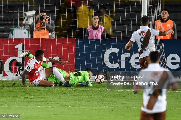 Colombia's Independiente Santa Fe forward Wilson Morelo kicks the ball against Chile's Santiago Wanderers goalkeeper Mauricio Viana to score his...