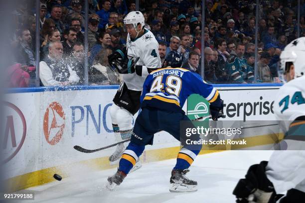 Ivan Barbashev of the St. Louis Blues checks Brenden Dillon of the San Jose Sharks at Scottrade Center on February 20, 2018 in St. Louis, Missouri.