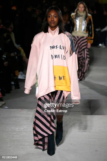 Model walks the runway at the Marques'Almeida show during London Fashion Week February 2018 on February 19, 2018 in London, England.