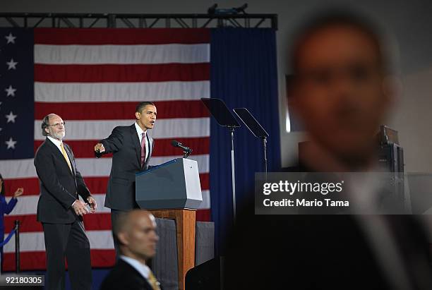 President Barack Obama speaks as New Jersery Governor Jon Corzine looks on with Secret Service agents keeping watch at a campaign rally at Fairleigh...