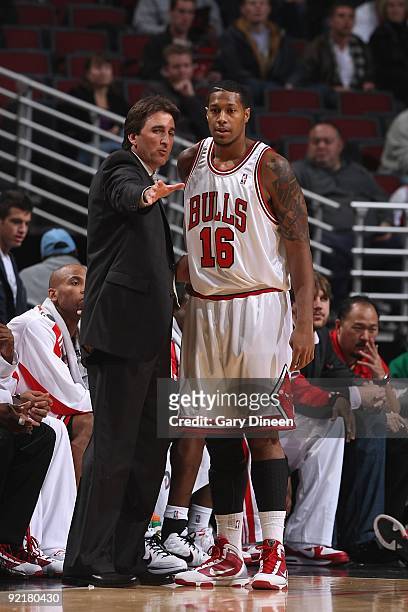 Head coach Vinny Del Negro talks with James Johnson of the Chicago Bulls during the preseason game against the Milwaukee Bucks on October 13, 2009 at...