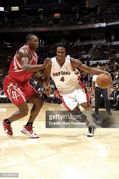Chris Bosh of the Toronto Raptors drives to the basket against Joey Dorsey of the Houston Rockets during a preseason game at Air Canada Centre on...